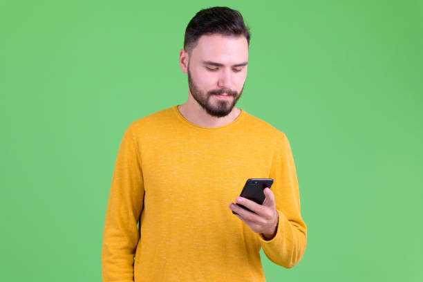 istock Portrait of young handsome bearded man using phone 1194202408