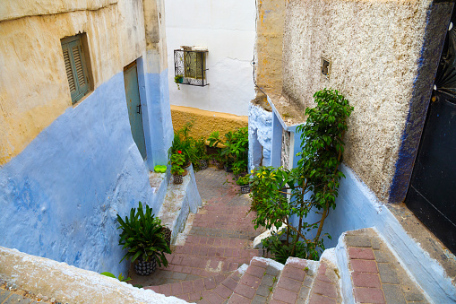 View of the one of the old colorful streets in the Tangier Medina quarter in Northern Morocco. A medina is typically walled, with many narrow and maze-like streets.