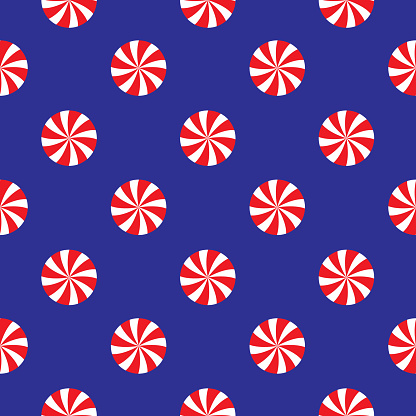 Vector seamless pattern of red and white swirl peppermint candies on a blue background.