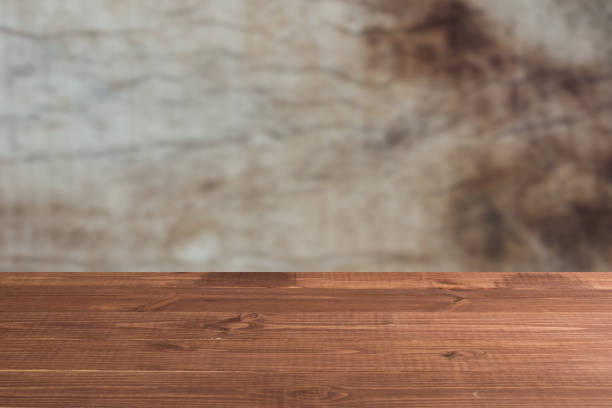 istock Wooden board empty table in front of a blurred background. Perspective brown wood over blurred wooden planks background - can be used to showcase or assemble your products. Mock up 1194209450