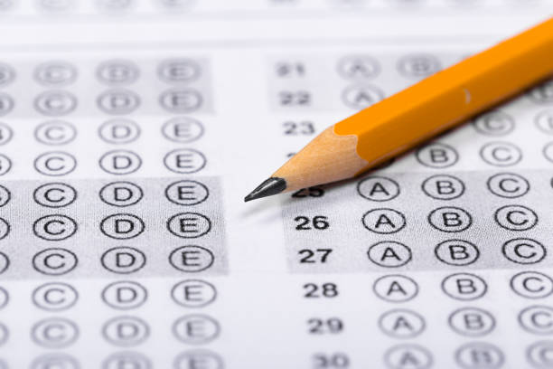 istock testing in exercise and exam paper. computer sheet with pencil in school test room, education concept 1194209460