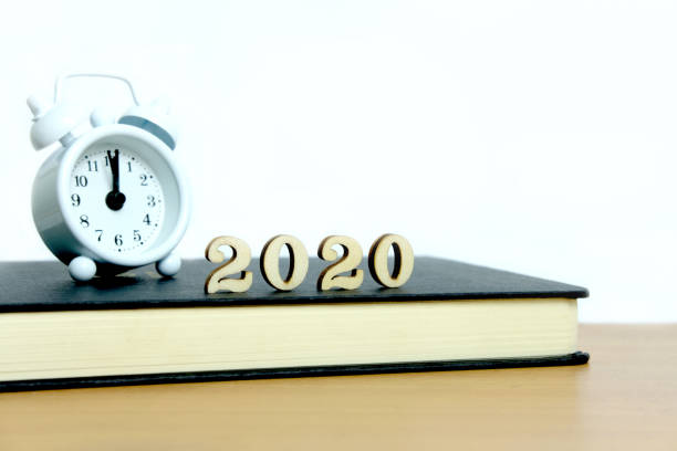 istock 2020 wooden number block with clock and book on a table 1194214085