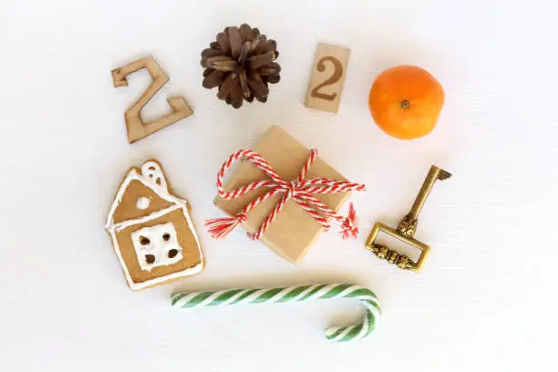 a gift with a house and a golden key, candy staff and New Year 2020