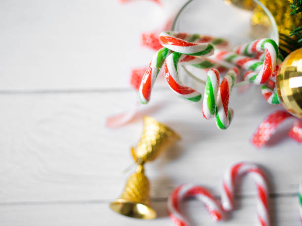 istock Heart shape christmas candy sticks and christmas tree on wooden table. 1194216317
