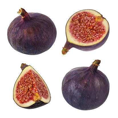Homegrown figs on a wooden board with a black background.