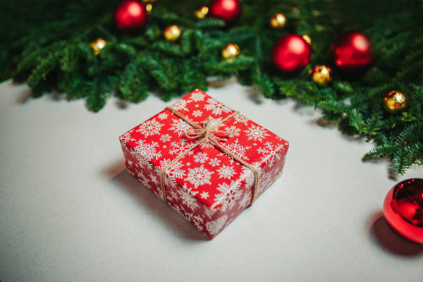istock Christmas composition. Christmas gift, fir branches on white background. Flat lay, top view, copy space. Red christmas balls and candy canes on the white background. 1194218870