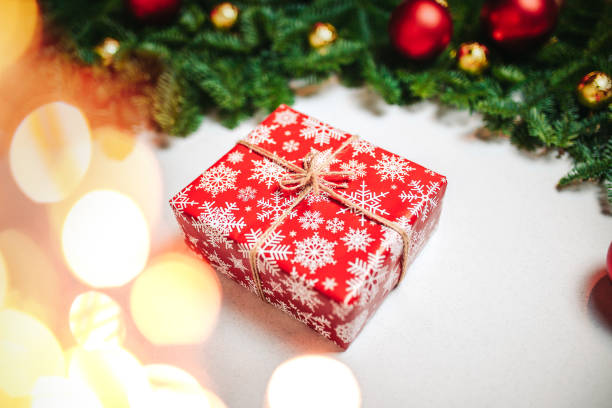 istock Christmas composition. Christmas gift, fir branches on white background. Flat lay, top view, copy space. Red christmas balls and candy canes on the white background. 1194218877