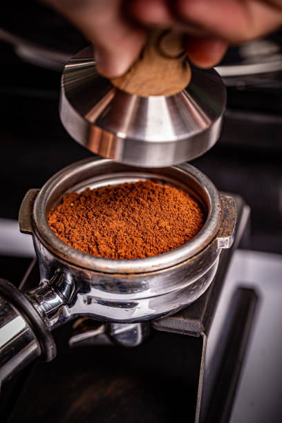 istock Barista presses ground coffee 1194218979