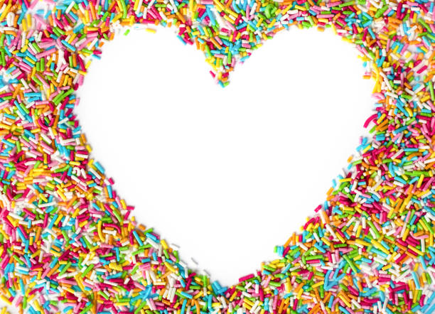 istock Heart shaped made from colored sprinkles. Heart shape with empty space for text in the centre of heart top view. Valentines Day background. 1194220218