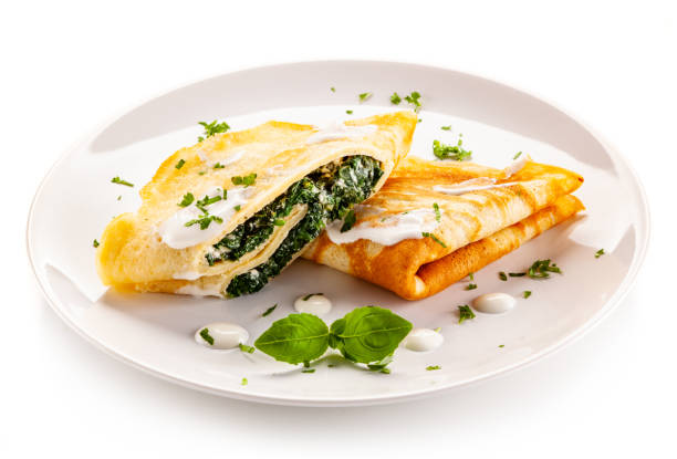istock Crepes with spinach and cream on white background 1194223593