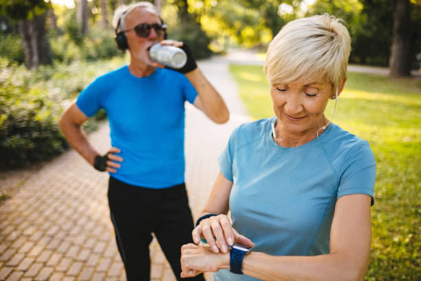 istock Senior woman using smart watch while exercising outdoors 1194226216