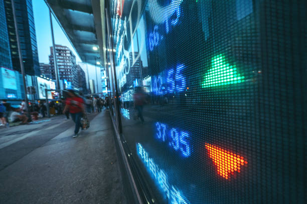 istock Display stock market numbers with graph and blurred people 1194229064