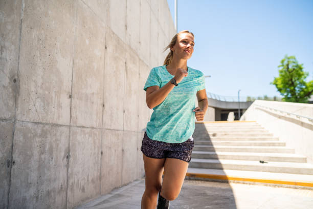 istock Female runner exercising in a public park 1194230937