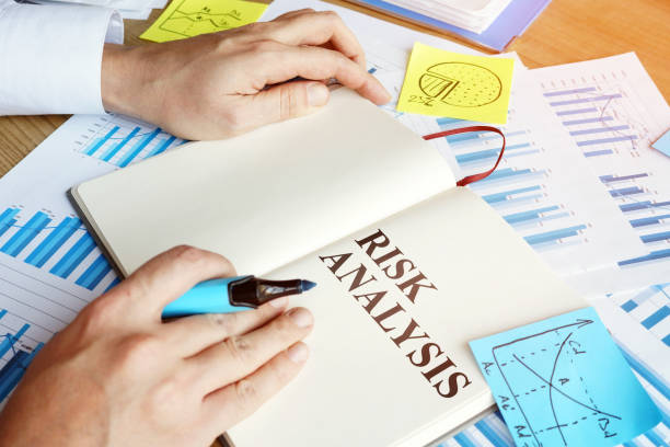 istock Businessman reads risk analysis report in the office. 1194231133