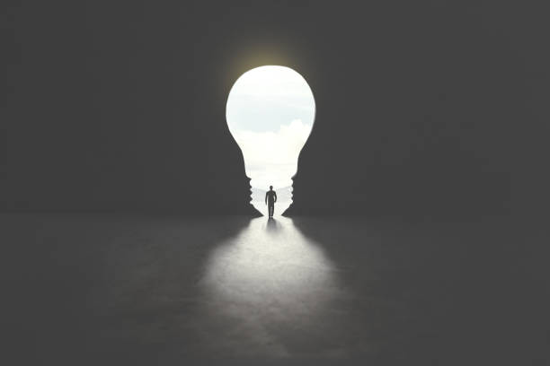 smart man walking through bulb shape door, creative concept stock photo