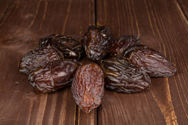 istock Dried date fruit on brown wood 1194232905