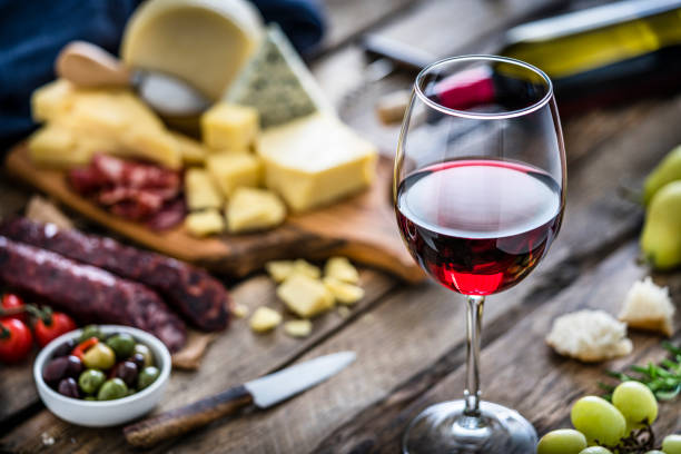 istock Appetizer: red wineglass, cheese and spanish chorizo on rustic wooden table 1194233978