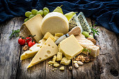 Cheeses selection on rustic wooden table