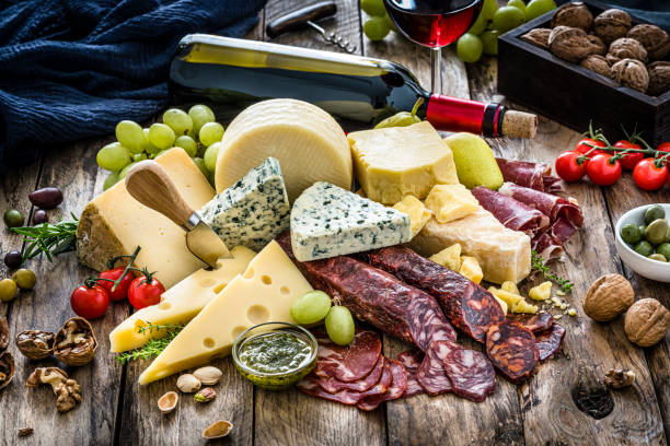 istock Appetizer: cheese, spanish chorizo and red wine on rustic wooden table 1194234343