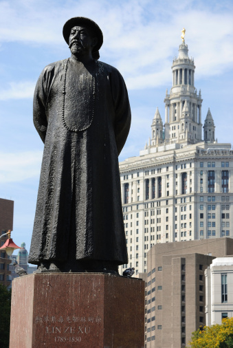 Lin Zexu statue in Chinatown, New York City. Lin Zexu is remembered as a pioneer in the war on drugs. Juxtaposed to the statue stands the Municipal Building in the background, an historic government building.