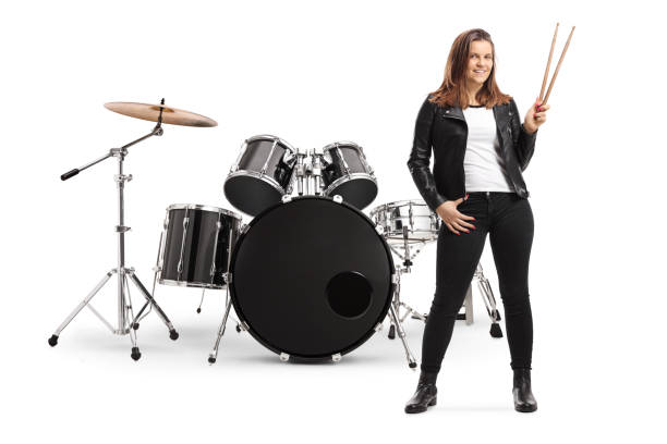 istock Young female posing with a drum set and holding drumsticks 1194235533