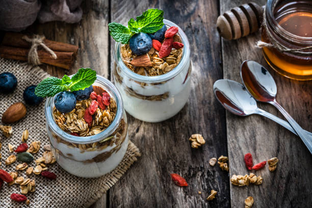 istock Healthy food: yogurt and granola on wooden table. 1194235774