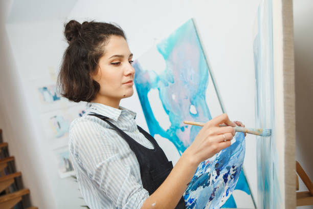 istock Concentrated woman focused on creative art-making process in art therapy 1194235908