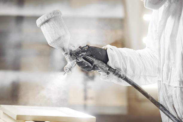 istock Man working with paint spray gun, airless spraying to wood 1194237406