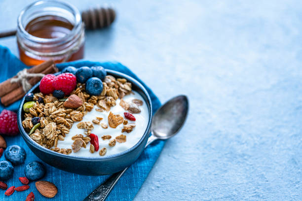 istock Healthy food: homemade yogurt and granola on blue table. Copy space 1194237496