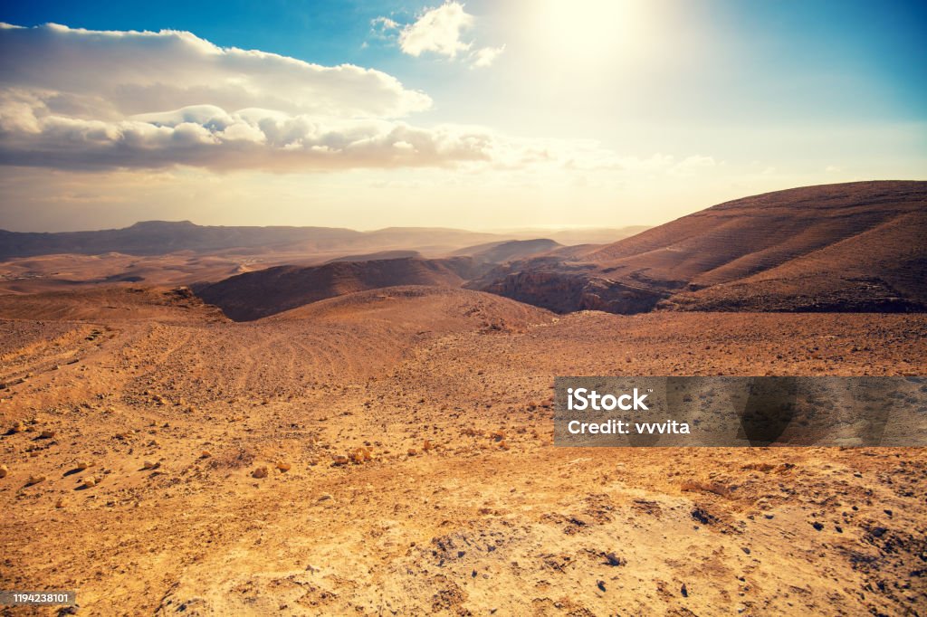 Mountainous desert with a beautiful cloudy sky. Desert in Israel at sunset Wilderness Stock Photo