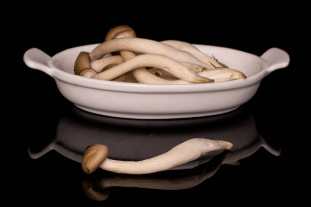 brown shimeji mushroom isolated on black glass - mushroom stem cap plate imagens e fotografias de stock