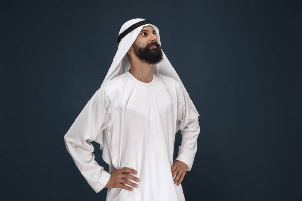istock Arabian saudi businessman on dark blue studio background 1194243306