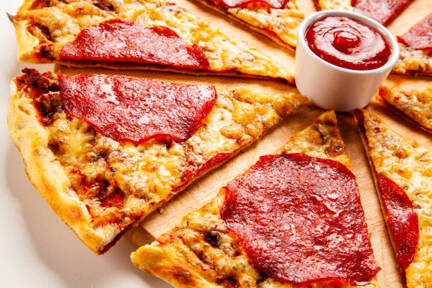 istock Sliced pepperoni pizza with salami and cheese on white background 1194243686