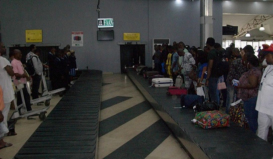 Maun International Airport, Botswana - December 19th 2022:  Passengers boarding a small jet aircraft, a Embraer190 ZS-YAY from FlyAirLink on the open tarmac in Maun Airport