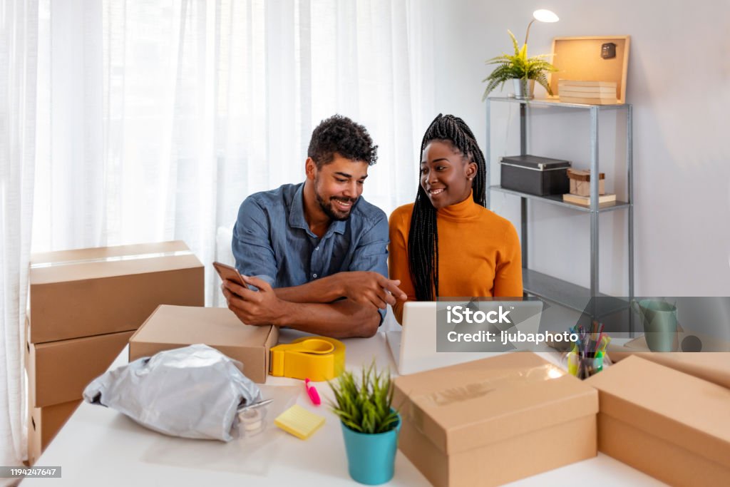 Male and female are looking their orders on laptop computer Happy young businessman with new startup business success, woman received great news and update preorder on laptop. They are working at modern home office. Concept business online. Small Stock Photo