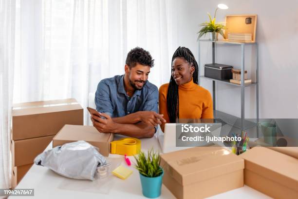 Male And Female Are Looking Their Orders On Laptop Computer Stock Photo - Download Image Now