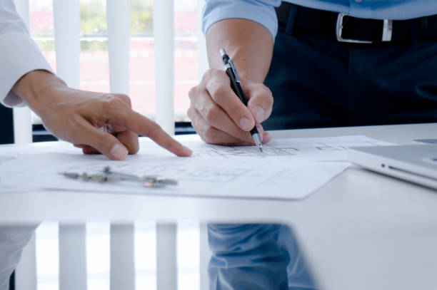 istock Colleagues interior designer Corporate Achievement Planning Design on blueprint Teamwork Concept with compasse. 1194247771