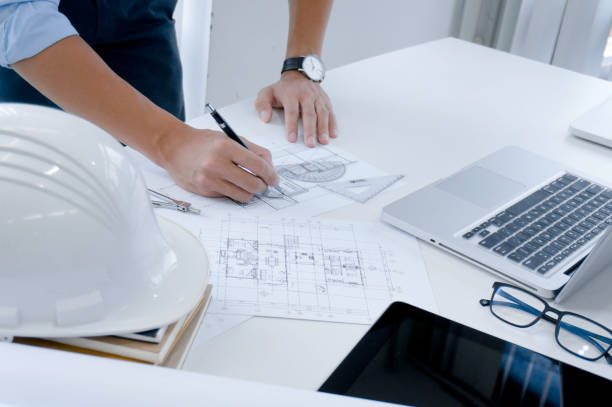 istock Colleagues interior designer Corporate Achievement Planning Design on blueprint Teamwork Concept with compasse. 1194249024