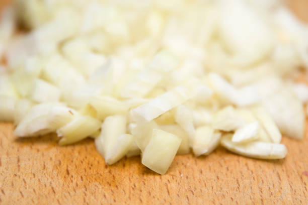 istock Chopped onions on wooden cutting board 1194249801