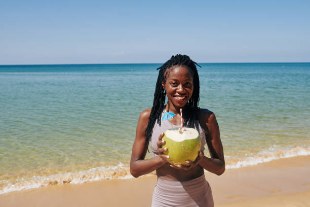 istock Young woman with big green coconut 1194249904