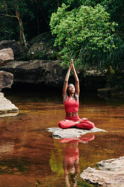 istock Young woman stretching after meditation 1194249919