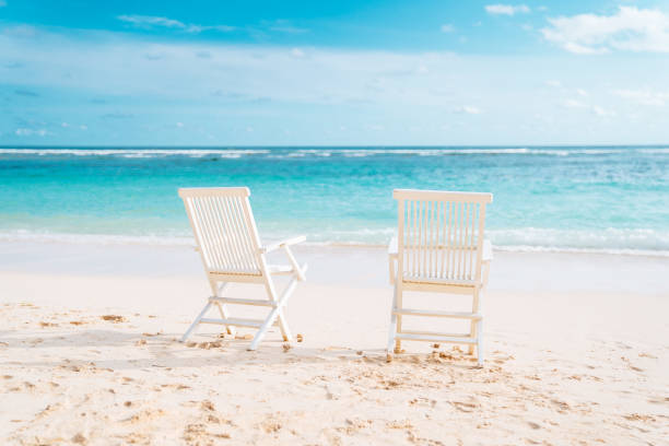 istock Two white chairs on the white sand beach 1194251288