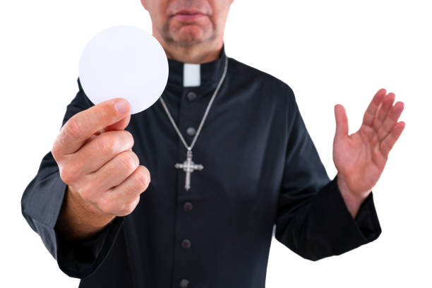istock Priest bald with communion wafer host 1194252609