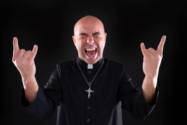 istock Priest bald rock and roll fingers crazy gesture 1194252625