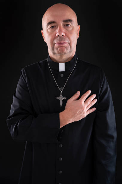 istock Priest hand in heart as a honesty gesture in dark 1194252661