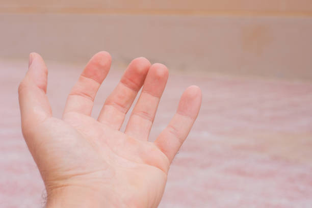 istock Conceptual open hand reaching out on soft orange background. Openness, giving, assistance and helping concepts. 1194254619