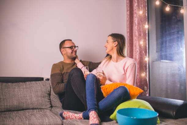 istock Couple chilling on the sofa with drinks 1194255348