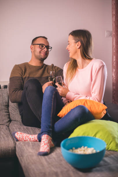 istock Couple chilling on the sofa with drinks 1194255559