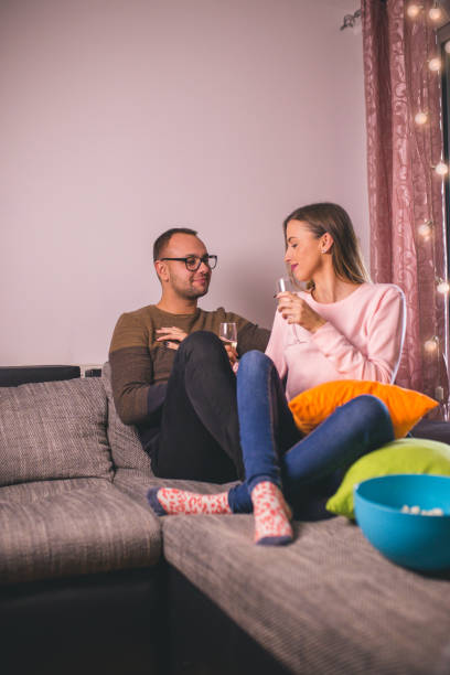 istock Couple chilling on the sofa with drinks 1194255631