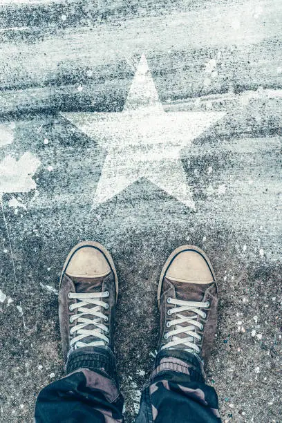 Photo of Standing on the road with star shape imprint